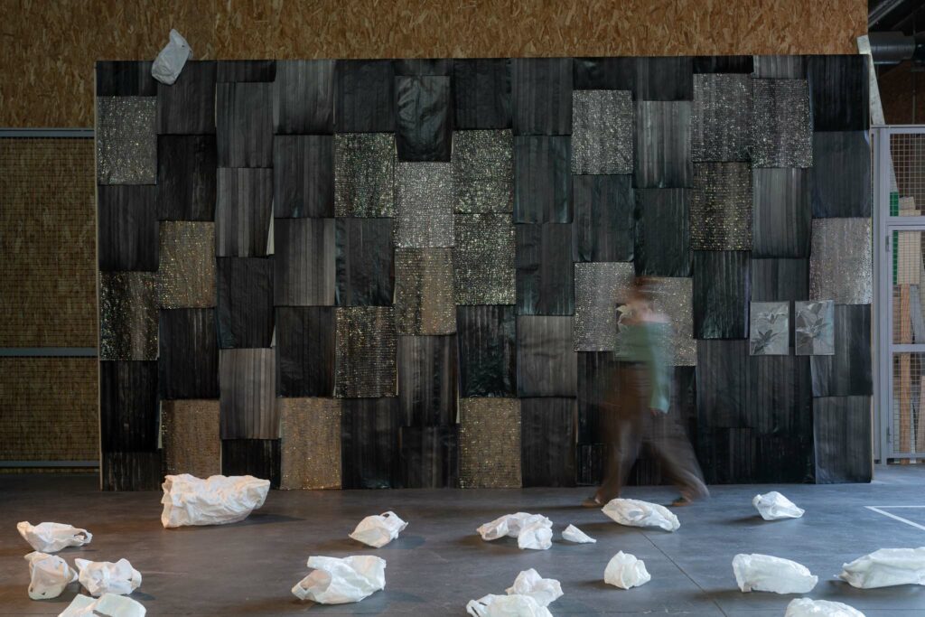 Une oeuvre d'art de Camille Fischer composée de tissu et d'éléments blancs au sol